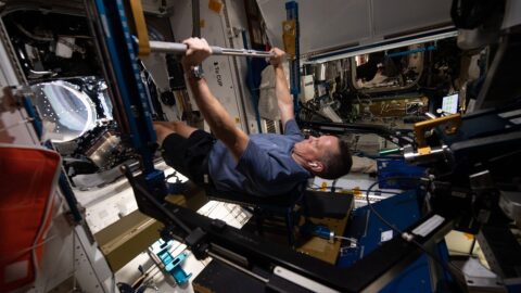 An astronaut exercising aboard a space station