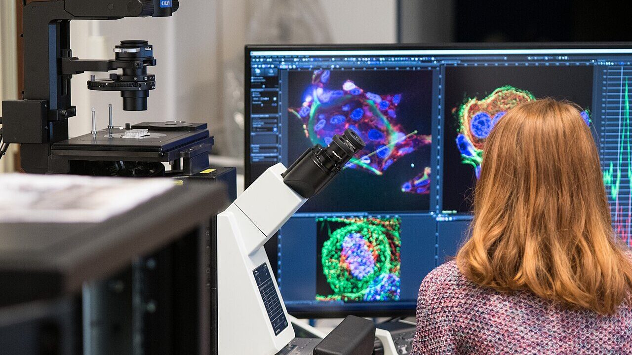 A researcher using a microscope in a laboratory