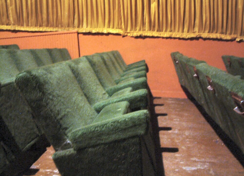 Empty green cinema seats in a classic theatre before the screening