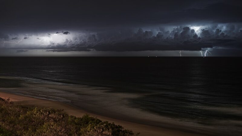 Lightning storm over the ocean at night